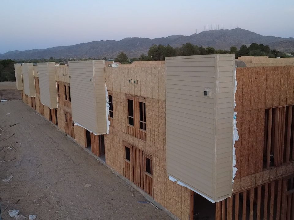 Aerial drone view of completed and in-progress stucco buildings