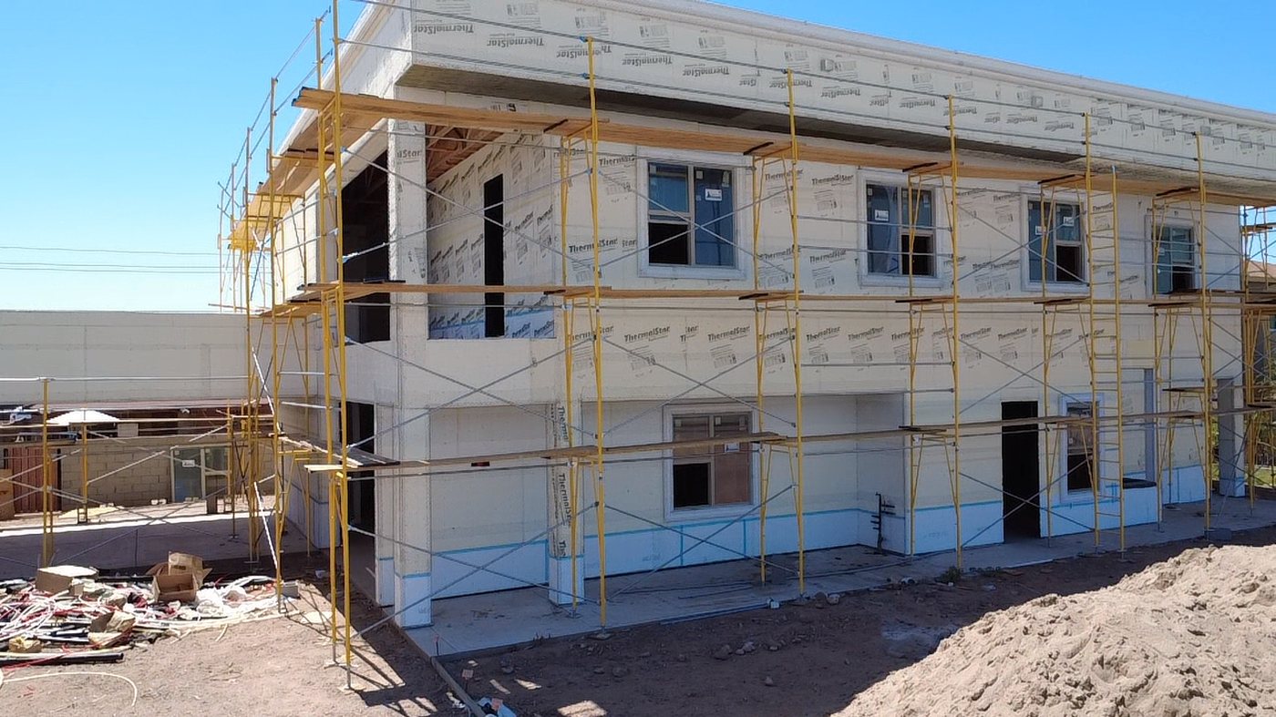 CCS lathe and moisture barrier installation with scaffolding on residential project